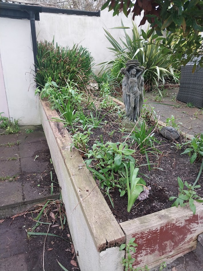 a corner flower bed in a garden