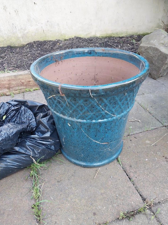 A large blue planter for potatoes